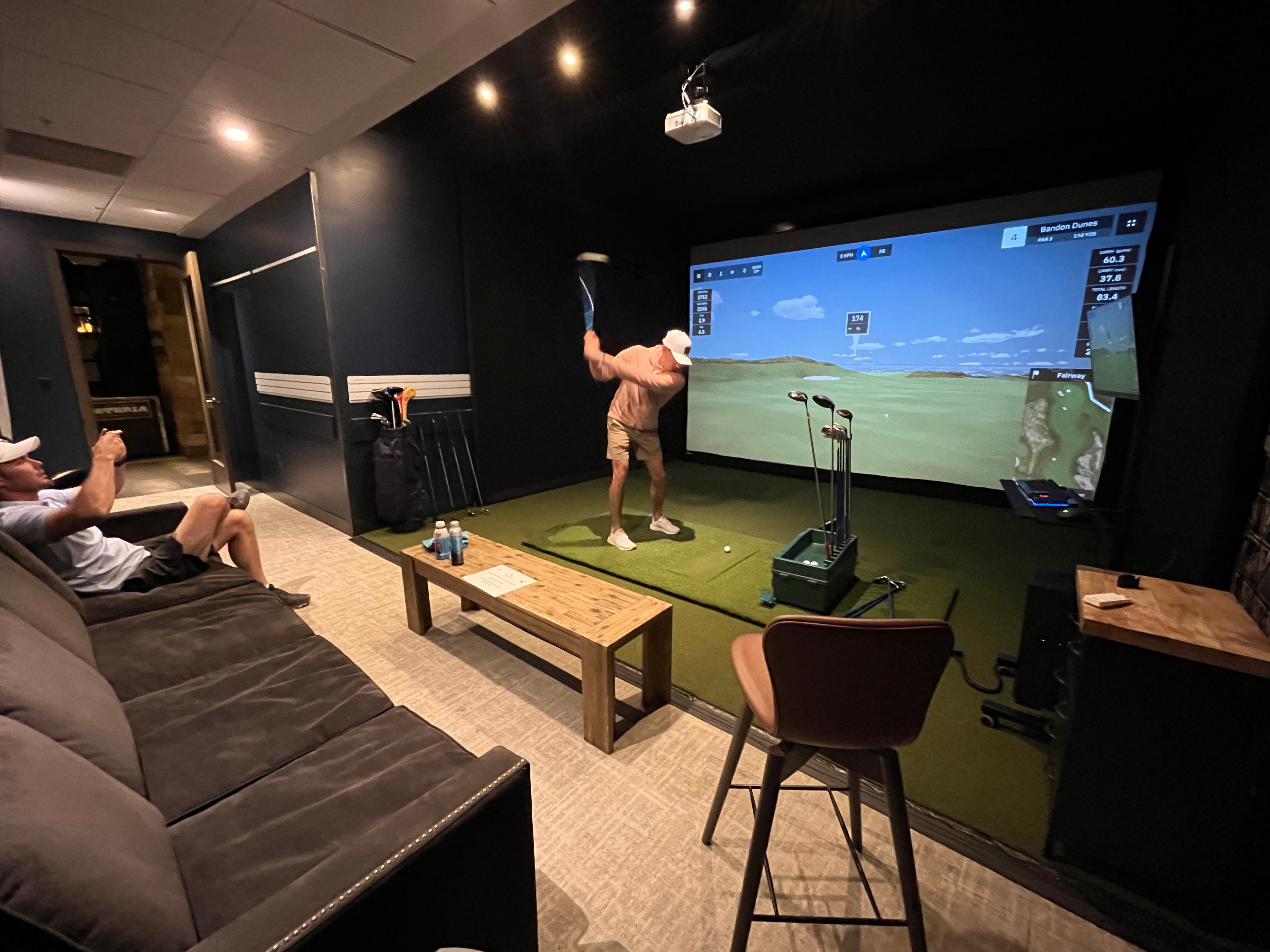 Playing golf on an indoor golf simulator at Hotel Terra in Jackson Hole, Wyoming